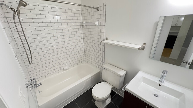 Newly remodeled upscale bath with wood plank flooring - Metropolitan Oxford Flats