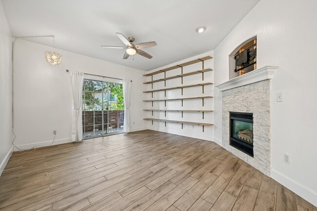 Living room with gas fireplace, bookshelves and tv mount ready - 8747 E Dry Creek Rd Unit 1612
