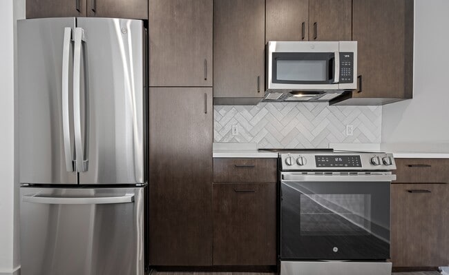 The Landing at Vinnin Square kitchen brings stainless steel appliances together with dark cabinetry.