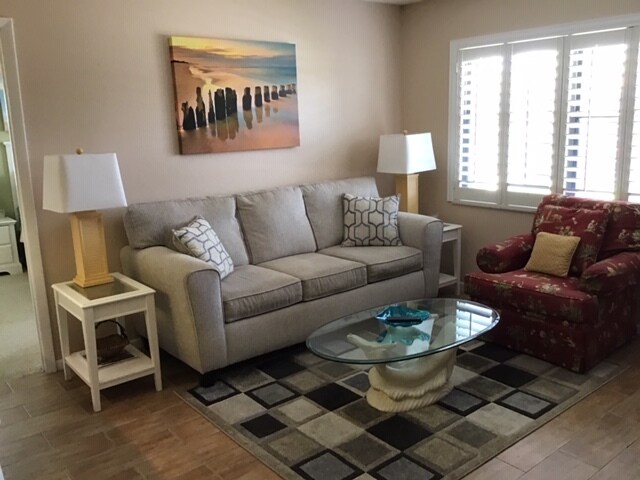light filled living room plantation shutters - 4345 27th Ct SW Condo Unit 202