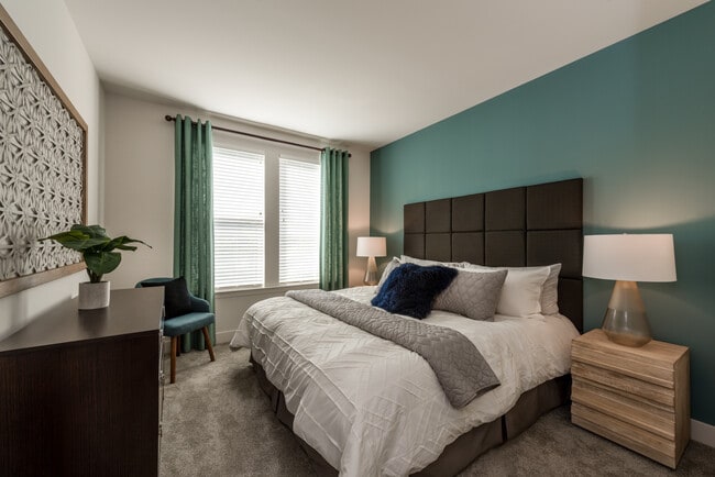 Bedroom with accent wall and carpeted flooring