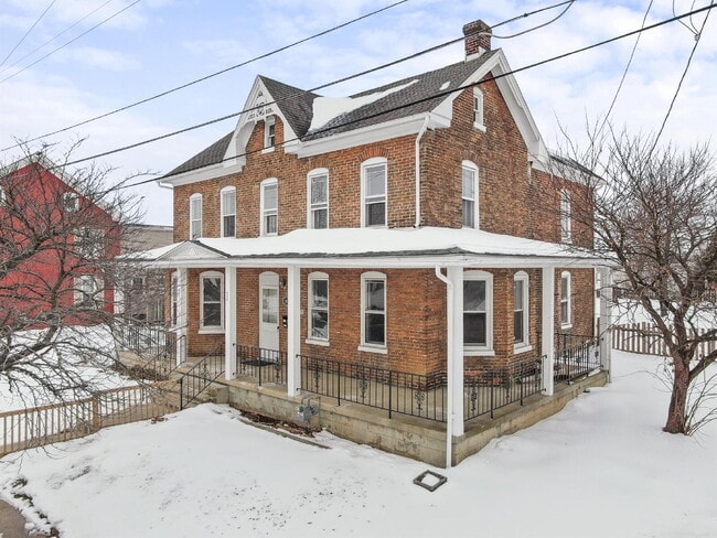 Photo - Charming 3-Bedroom Single-Family Home with Wrap-Around Porch & Private Fenced Yard