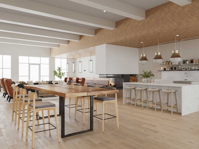 Casa club para residentes y espacio de reunión comunitaria con techos altos, asientos modernos y diseño abierto en los apartamentos Cresta Ranch en Santa Fe, Nuevo México.