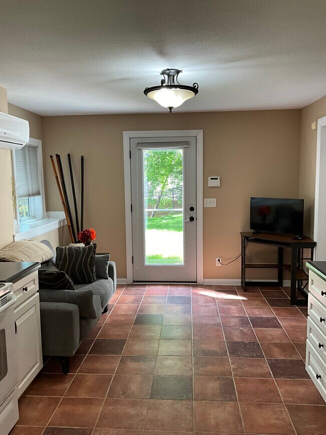 Front door in open concept sitting room and kitchen - 2455 Sunrise Dr Unidad Cozy and quiet 1 bed