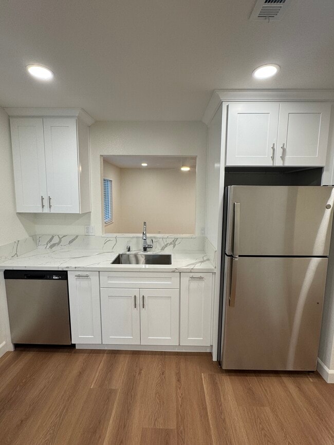 Kitchen sink/refrigerator - 4903 Cowell Blvd Unit Oasis Apartments A C D