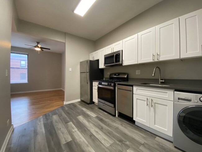 Kitchen with stainless steel appliances - 2801 W Logan Apartments