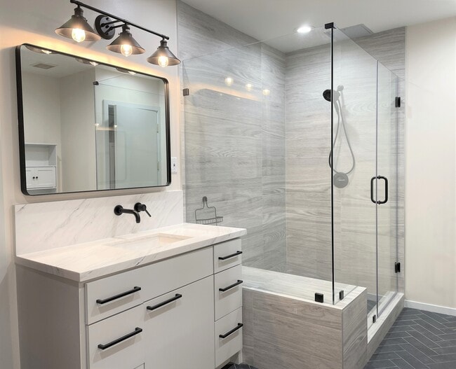 Updated bath with separate his and hers vanity, and large walk-in shower