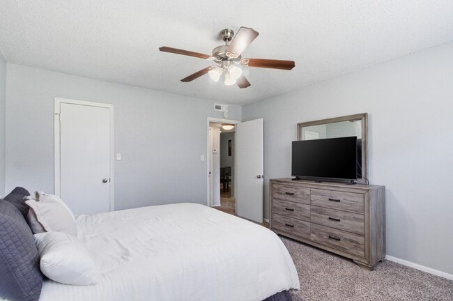 Unwind in a spacious, comfortable bedroom at Aspen Run Apartments in Tallahassee, perfect for rest and relaxation.
