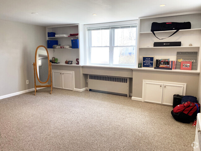 Den with ample sunlight and bookshelves - 110 Dobson St Unit LL Rental