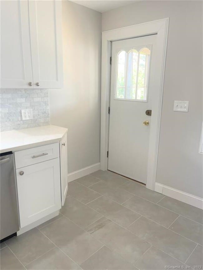 Kitchen walks out to screened in porch and rear fenced in yard - 10 Treadwell St