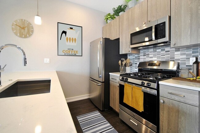 3rd Floor w/ Custom Backsplash - Light Wood Finish - The Phoenix at Troy Crossing Apartments