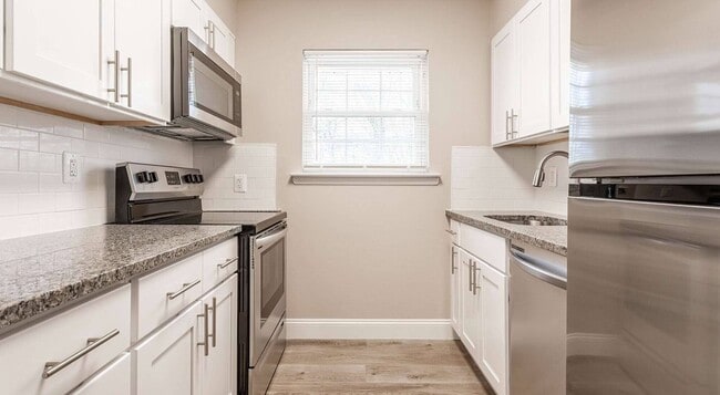 Transform your lifestyle at Toms River Apartments. This stunning kitchen features modern appliances, sleek countertops, and ample natural light, perfect for culinary enthusiasts. Don't miss out on your dream home—schedule a visit today! - Toms River Apartments