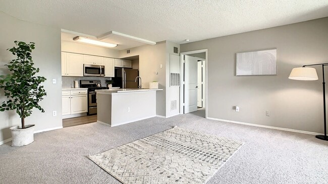 This spacious living area flows seamlessly into the kitchen, creating an inviting space for relaxing, entertaining, and enjoying everyday life at home.