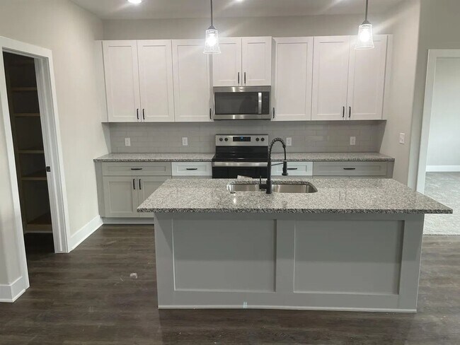 Photo - Single family slab home with three car garage. This home is 4 bedrooms, three bathrooms open floo...