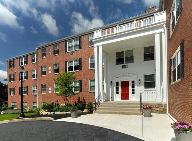 Crestwood Apartments in Wayne, PA – Classic brick exterior and welcoming red door entry with colonial charm