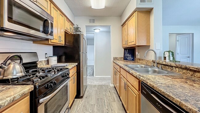 Experience the joy of cooking in our modern gourmet kitchen, featuring stainless steel appliances, granite-style countertops, and ample cabinet space.