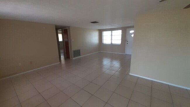 Photo - 2/1.5/1 1000 Sq. Ft. Spacious living room, Lanai, fenced in yard, and tile floors thoughout!