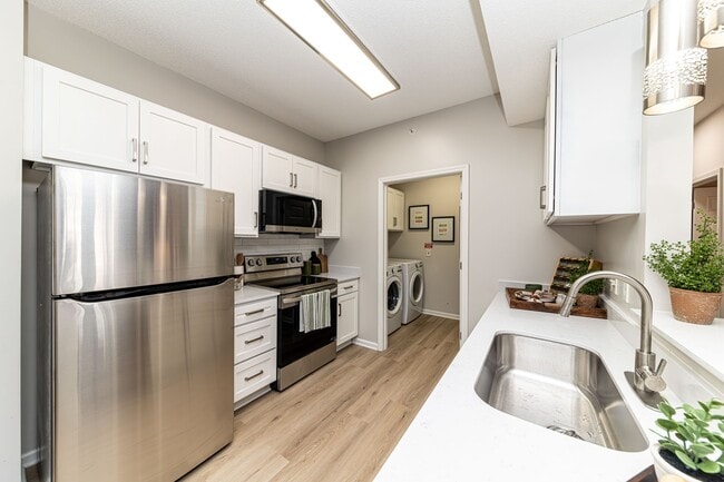 Kitchen with quartz counters, modern cabinetry, & stainless appliances - The Slates at Powdersville