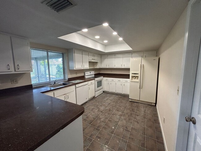 Photo - Freshly painted interior and new carpet in living room spacious home off Country Club Blvd
