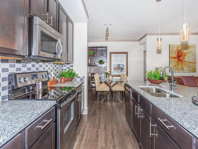 Kitchen with Granite countertops and island - Plantation Park Apartments