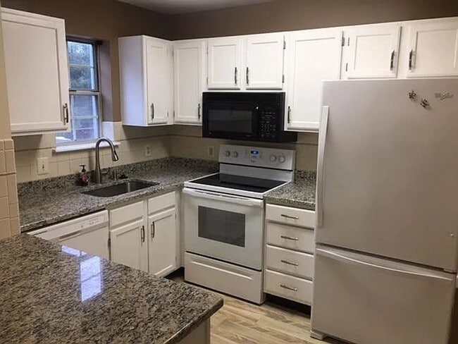 Photo - Spacious 3BR Townhome with Walkout Basement, Deck, Fenced Yard, Central A/C + Assigned Parking