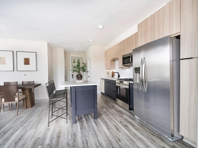 Sleek kitchens at Modera Westside Trail feature a spacious island and multiple contemporary finish options, creating a refined space for everyday living.