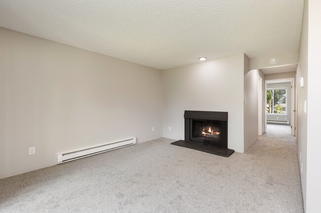 Living Room with heating, carpet, and fireplace in 1 bedroom apartment