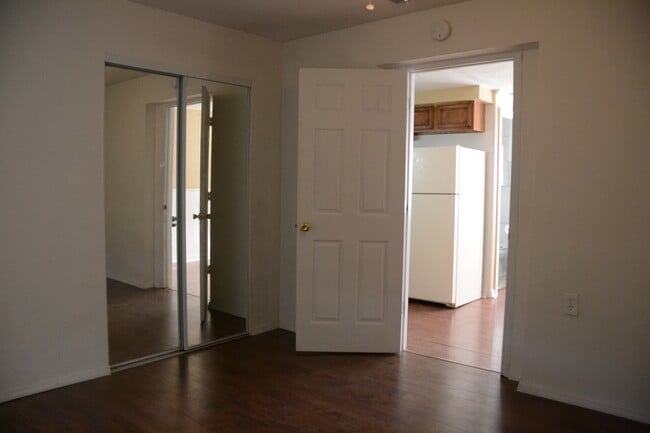 bedroom with double mirror doors.