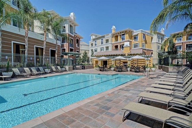 Outdoor pool and spa area with expansive sun deck and Wi-Fi access