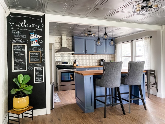 Open layout kitchen with an island, stainless steel appliances, and butcher block counter tops. - 1012 Englewood Ave