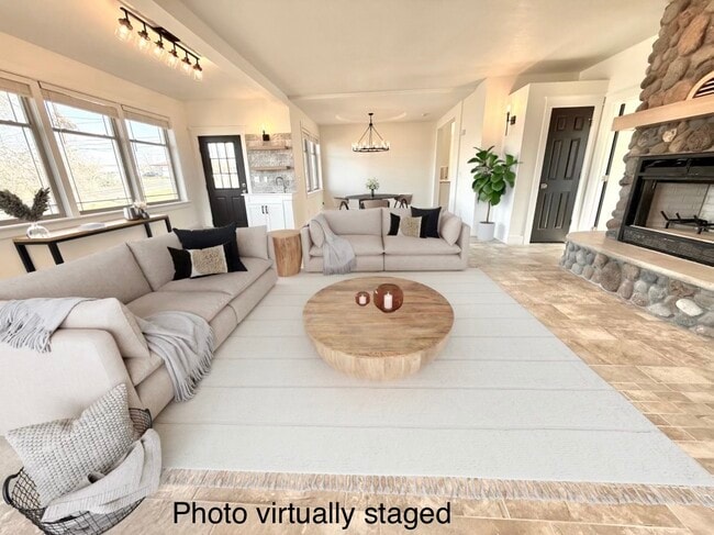 Virtually staged living room looking into dining. Door on left to exterior deck. - 24 Ash St N