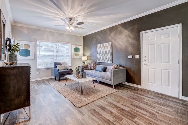 Spacious Living Room with hard wood floors and ceiling fans - Parkways on Prairie Creek