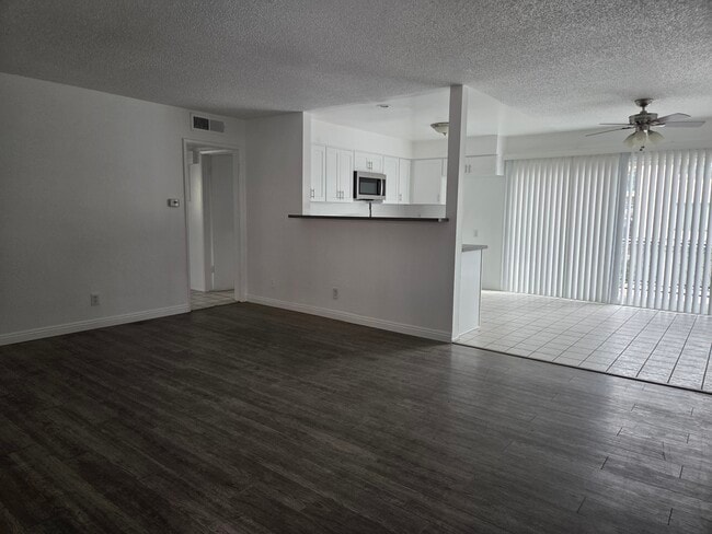 Living room with luxury vinyl plank flooring - 3455 Elm Ave Unit #215