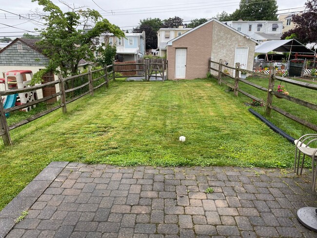 Photo - 3BR Twin Home | Hardwood Floors • Fenced Yard • Garage • W/D Included