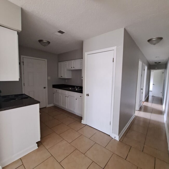 Photo - This 2BR/1BA includes a nice-sized living area, an ample kitchen, a fenced-in