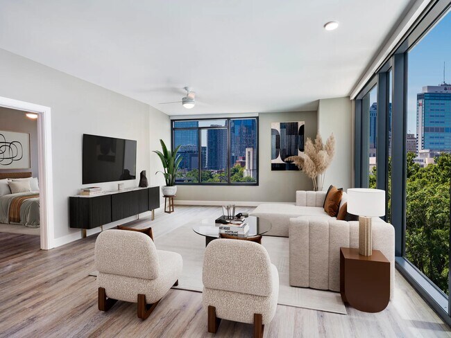 Choose homes with floor-to-ceiling windows that showcase downtown Nashville views, enhancing every moment at Modera McGavock with natural light and modern elegance. - Modera McGavock