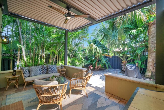 Elevated patio with remote controlled sun roof overlooks lush landscaping with 6' privacy fence to c - 1109 NE 3rd St Casa