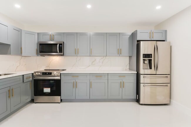 Photo - Fully renovated stylish 3 bed 2 bath home featuring a luxury kitchen, modern appliances on a fenc...