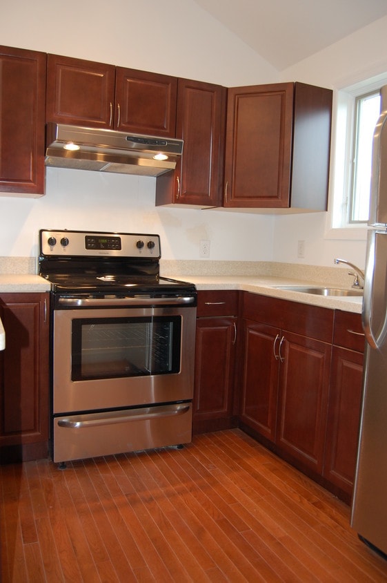 New kitchen with extensive cabinet space; Stainless steel gas range. - 485 Elmwood Ave Unit 6
