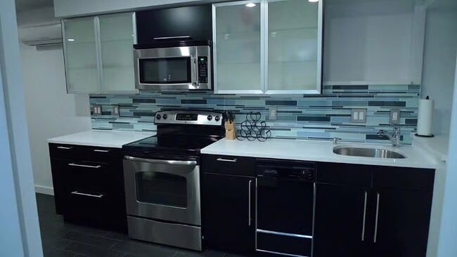 Full size Kitchen supplied with utensils, pots / pans, plateware, dishwasher & disposal. - 2300 Ontario Rd NW Unit B Furnished