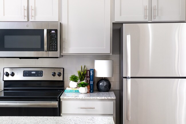 Kitchens with premium granite countertops and stainless steel appliances