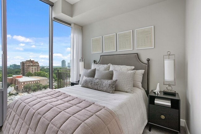 A serene bedroom retreat filled with natural light, featuring expansive windows, inviting textures, and a thoughtfully designed space for rest and recharge