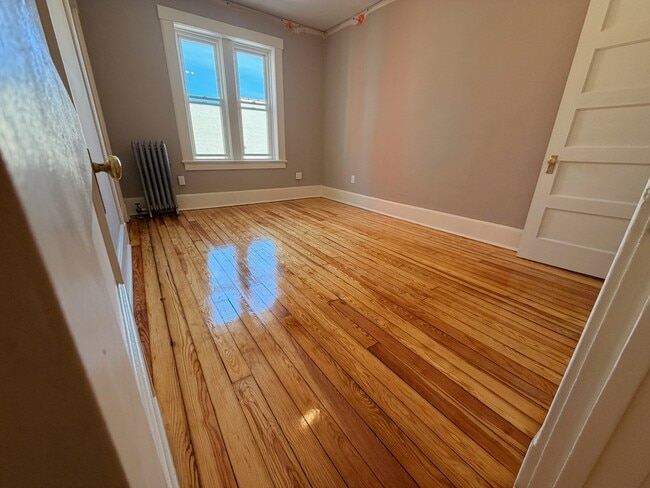 Large bedroom with hardwood floors - 69 S Pleasant St