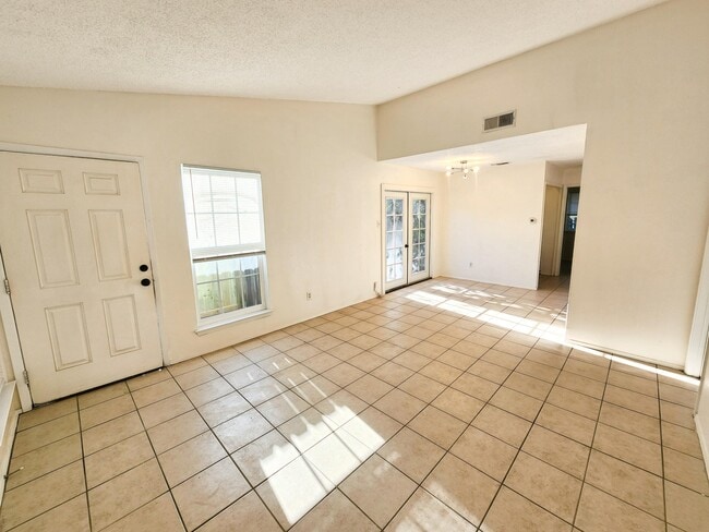 Living room / den area with high ceiling and plenty of natural light. - 111 Meteor Dr Unit A