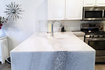Open kitchen with waterfall countertop. - 8208 Heritage Club Dr House