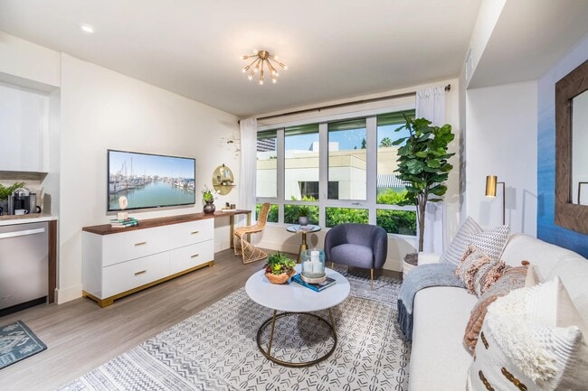 Open-concept living area with oversized windows bringing in abundant natural light.