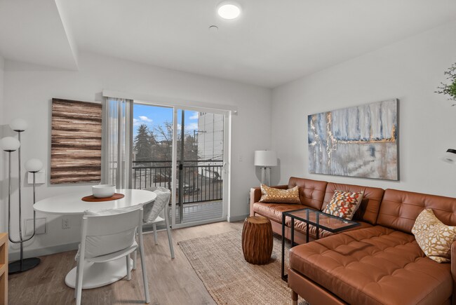 Bright living and dining area with access to a private balcony.