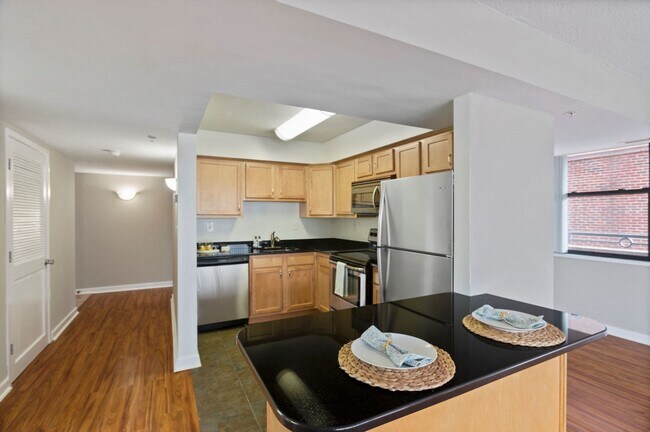 Two-bedroom apartment kitchen with stainless steel appliances and bar area