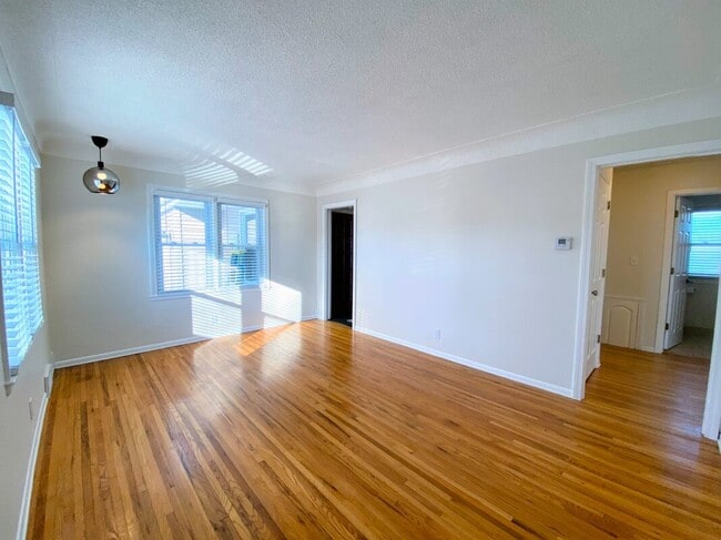 Living Room - Gleaming hardwood floors and abundant natural light - 710 Sheridan Avenue North