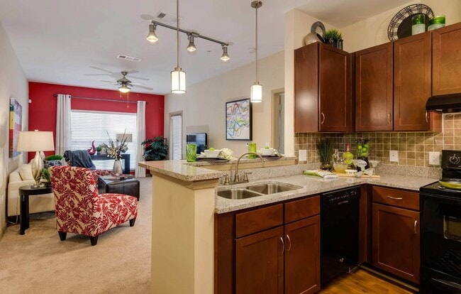 Open Kitchen with deep sink and bar for dining overlooking, spacious carpeted living room